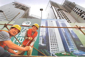 Workers toil on a new housing project in Beijing.