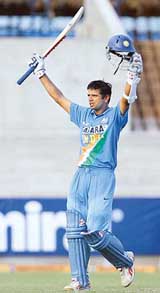 Rahul Dravid celebrates on completing a century during the first one-dayer against the West Indies