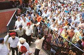 Agitated students and parents outside Government College for Girls, Sector 11, waiting for information about CET in Chandigarh on Saturday. 