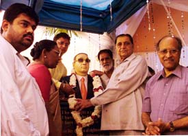 Education Minister Harnam Dass Johar garlands a statue of Dr E.M. Johnson, founder of the Vocational Rehabilitation Training Centre for the Blind and Disabled