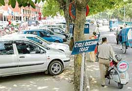 A cycle track in Sector 35, which has been encroached upon by a contractor to make place for parking of four-wheelers.