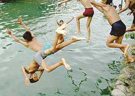 Children take full advantage of summer vacation by having a splash in a pool near Gandhi Bhavan of Panjab University in Chandigarh on Sunday.