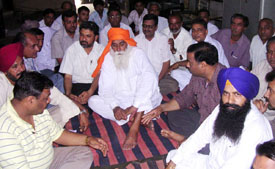 Office-bearers of various organisations of the Ahmedgarh area discuss the issue of the proposed bypass at Pohir on the Ludhiana-Malerkotla road on Sunday