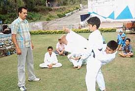 Students learn self-defence techniques from National Martial Art Instructor Sukhjeevan Sharma at DAV Senior Secondary School, Surajpur, on Monday.