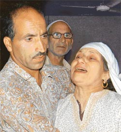 A woman wails after her son got injured in a grenade blast in Raniwari in Srinagar on Monday