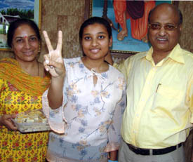 Veenu Singla of DAV School, who secured second position in Ludhiana in the commerce stream, with 94.6 per cent marks with her school Principal, Mr R.S. Patial, in Ludhiana