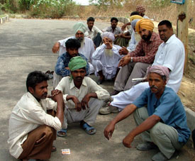 Relatives of the deceased labourers and residents of Jainpur village wait outside the Civil Hospital where the post-mortem examination of the victims