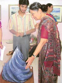 Ms Aditi Dua looks at the intricacies of a sculpture after inaugurating an art gallery in Mohali
