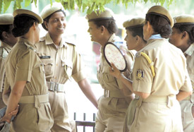 Policewomen gather under the shade of a tree with one of them using the trusted hand fan to beat the onslaught of heat in the Capital on Wednesday. 