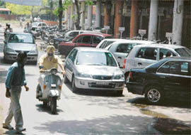 The haphazardly parked cars on the road in front of Mehfil restaurant in Sector 17, Chandigarh, which has been auctioned as a parking place for two-wheelers only, leading to bottlenecks on this narrow stretch.