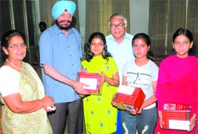 Ruchi Gupta, Sarita and Aditi Gupta, students of the Khalsa College Lyallpur of Laws for Women, recieving awards from the colleges president Balbir Singh in Jalandhar