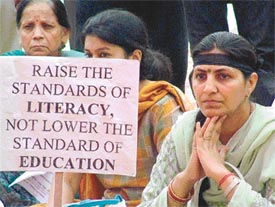 People sit in dharna in support of doctors, who are on fast against the governments proposed reservation policy, at the AIIMS, in New Delhi on Thursday