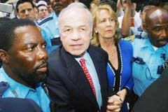 Enron Corp's founder Kenneth Lay  leaves the courthouse with his wife, Linda Lay