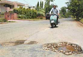 Potholes on a B-road in Sector 6 reflect the bad condition of roads in Panchkula