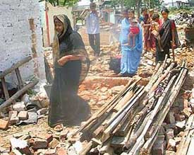 Slum dwellers carry their belongings to a new site allotted by PUDA in Phase-8, Industrial Area