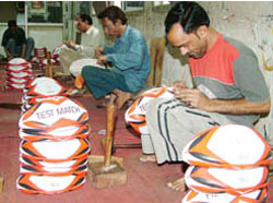 Workers sew rugby balls at a sports goods factory in Jalandhar.