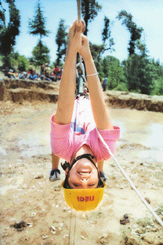 A zesty girl gets the thrill of rope climbing at a summer camp