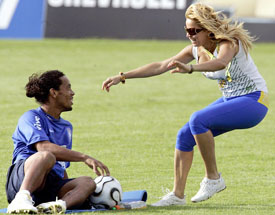 A fan runs onto the pitch to embrace Brazilian striker Ronaldinho