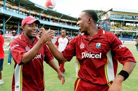West Indies captain Brian Lara and Dwayne Bravo celebrate the series-clinching victory over India in the fourth one-dayer at the Queens Park Oval in Port of Spain on Friday