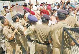 Members of the Government Teachers Union, Punjab, try to break the barricade near the residence of DPI in Sector 27, Chandigarh, on Sunday