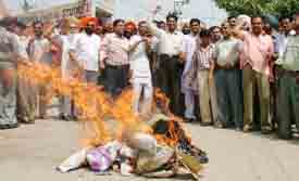 Activists of the BYJM burn an effigy of the UPA government in protest against rising prices, in Ludhiana
