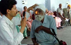 A doctor examines a patient at an eye check-up camp organised by the Maa Bhagwati Club and the Bharat Vikas Parishad at Deep Nagar, Ludhiana