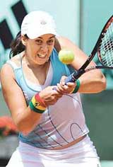 Frances Marion Bartoli returns a shot to compatriot Aurelie Verdy during their match at the French Open in Paris on Sunday