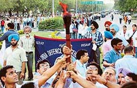 Doctors hold the "anti-reservation" torch aloft during the formation of a human chain along the Madhya Marg in Chandigarh