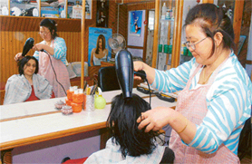 Barbara Hugh at work in her beauty salon.