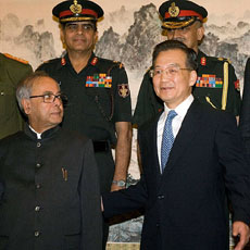 Defence Minister Pranab Mukherjee and Chinese Premier Wen Jiabao (right) pose for photographs  prior to talks in Beijing on Tuesday.