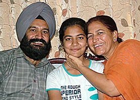 Supreet Kaur, who topped in the Jalandhar district in the CBSE Class X examination, along with her parents in the city. The student of Sant Dass School secured 96.8 per cent in the examination.