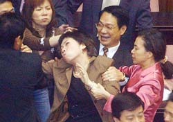 Taiwan Opposition lawmakers pull the hair of ruling Democratic Progressive Party deputy Wang Shu-hui