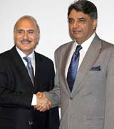 Indian Home Secretary V.K. Duggal shakes hands with his Pakistani counterpart Syed Kamal Shah
