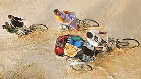 Commuter try to find their way through the rain water on the road separating Sectors 36 and 42 in Chandigarh on Wednesday.