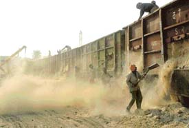 A thick cloud of dust caused by the unloading of wagons of gypsum engulfs a portion of the Chandigarh railway station, posing a serious threat to the residents of nearby area.