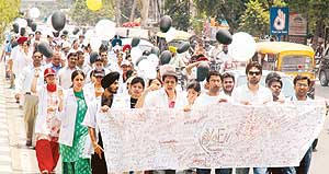 Medicos carrying a banner signed with blood take out a protest march against reservation in Ludhiana on Wednesday.