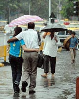 As the monsoon hit Mumbai way ahead of its scheduled arrival, a couple try to save themselves from the showers in the city on Wednesday
