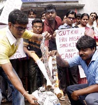 People burn packets of gutkha and cigarettes on the occasion of World No-Tobacco day in Kolkata