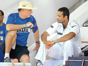 Irfan Pathan listens to coach Greg Chappell before the start of a two-day warm up match against Antigua XI in St. John's on Tuesday.