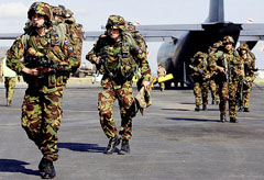 The first contingent of New Zealand soldiers disembarks from a C 130 Hercules on their arrival at Dili Airport, East Timor