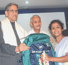 Delhi Lt.-Governor B. L. Joshi hands over a rucksack to a participant of Kailash Mansarovar Yatra 2006 at Raj Niwas in the Capital on Thursday. 