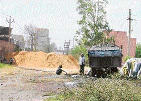 A tractor-trailer being filled with flyash outside a dyeing unit at the Focal Point in Ludhiana