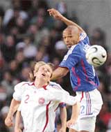Thierry Henry of France vies for the ball with Denmarks Christian Poulsen during a friendly at the Bollaert stadium in Lens on Wednesday