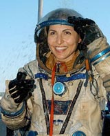 Entrepreneur Anousheh Ansari of the US smiles as she wears a space suit