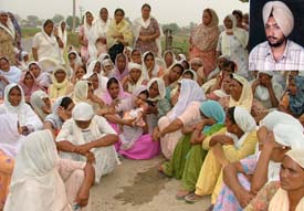 Women mourn the death of Harpreet Singh (inset), sarpanch of Muteon village, who was murdered along with his friend Mandeep Singh at the Civil Hospital, Samrala, on Thursday night