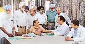 A doctor from the DMCH examines a patient at a free medical check-up camp organised for pensioners in Ludhiana