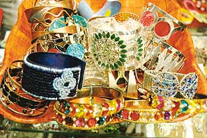 Dazzlers & sparklers: Traditional bangles encrusted with semi-precious stones and (bottom) jazzy plastic bangles studded with glamour at Dewsun, Chandigarh.