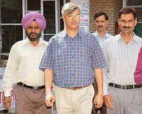Mr Ashish Vajpai, official liquidator of the Ministry of Company Affairs, being produced before the special judge by CBI officials in Sector 17, Chandigarh