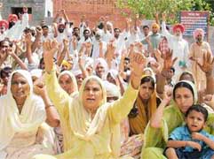 Supporters of Ms Veerpal Kaur at a dharna outside Balluana police post on Sunday.
