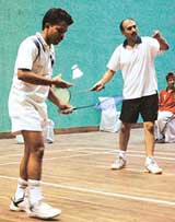 A doubles match in progress during the North Zone Audit and Accounts Badminton Tournament in Sector 42